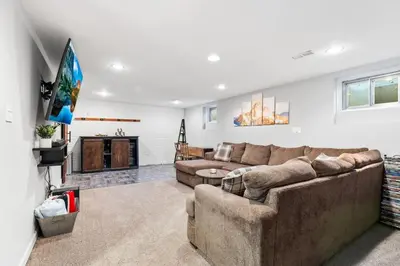 a living room with a couch and a tv at Creekside Family Haven in Arvada