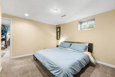 a bedroom with a large bed with blue pillows at Creekside Family Haven in Arvada