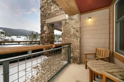 a balcony with a bench and a view of the mountains at Premium Unit 2216 - 1 Br - Zephyr Mountain Lodge condo in Winter Park