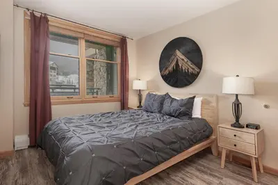 a bedroom with a large bed and a window at Premium Unit 2216 - 1 Br - Zephyr Mountain Lodge condo in Winter Park