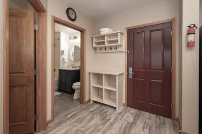 a bathroom with a toilet and a clock on the wall at Premium Unit 2216 - 1 Br - Zephyr Mountain Lodge condo in Winter Park