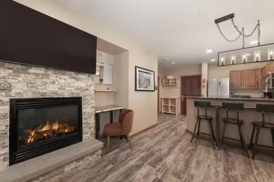 a living room with a fireplace and a kitchen at Premium Unit 2216 - 1 Br - Zephyr Mountain Lodge condo in Winter Park