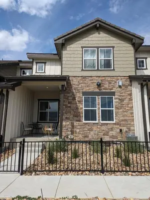 a house with a fence in front of it at Lovely Townhome at the TPC Golf Course in Berthoud