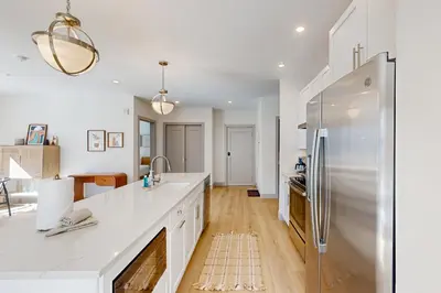a kitchen with white counters and a stainless steel refrigerator at Skywalk Flats Escape in Silverthorne