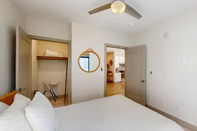 a bedroom with a white bed and a ceiling fan at Skywalk Flats Escape in Silverthorne