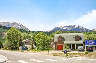 a house on a street with mountains in the background at Skywalk Flats Escape in Silverthorne