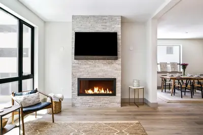 a living room with a fireplace with a tv at Skywalk Flats Escape in Silverthorne