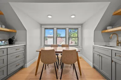 a kitchen with a wooden table and chairs at Broadway Dog-Friendly Loft with Parking in Denver