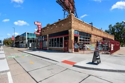 a brick building with a sign in front of it at Broadway Dog-Friendly Loft with Parking in Denver