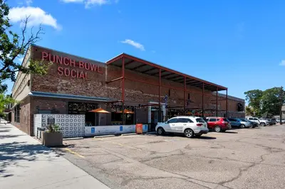 a building with a car parked in a parking lot at Broadway Dog-Friendly Loft with Parking in Denver