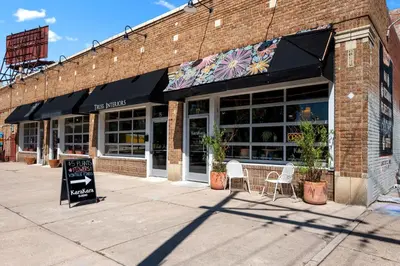 a store front with chairs and a sign in front of it at Broadway Dog-Friendly Loft with Parking in Denver