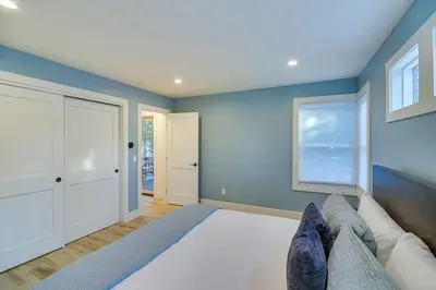 a bedroom with a large bed and blue walls at Mtn Escape with Hot Tub, By Trails in Grand Lake! in Grand Lake