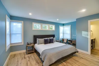 a bedroom with blue walls and a bed and a desk at Mtn Escape with Hot Tub, By Trails in Grand Lake! in Grand Lake