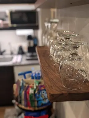 a row of wine glasses sitting on top of a counter at Cliff's Edge Brewing BBnB in Denver