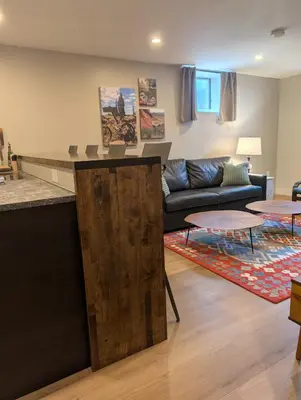 a living room with a couch and a table at Cliff's Edge Brewing BBnB in Denver