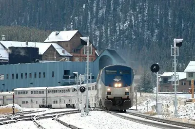 a train traveling down the tracks in the snow at Best Ski Condo, Winter Park, USA in Winter Park