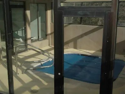 a view of a swimming pool through a glass door at Best Ski Condo, Winter Park, USA in Winter Park