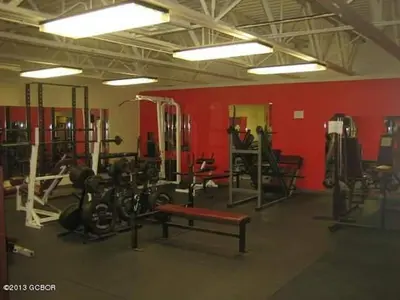a gym with bikes and weights and a red wall at Best Ski Condo, Winter Park, USA in Winter Park