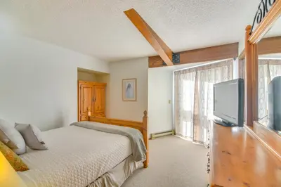 a bedroom with a bed and a flat screen tv at Pool and Hot Tub Access Condo in Winter Park! in Winter Park