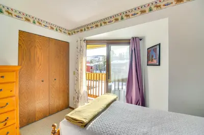 a bedroom with a bed and a window at Pool and Hot Tub Access Condo in Winter Park! in Winter Park