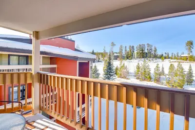a balcony with a view of a snow covered yard at Pool and Hot Tub Access Condo in Winter Park! in Winter Park