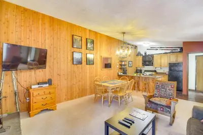 a living room with a kitchen and a dining room at Pool and Hot Tub Access Condo in Winter Park! in Winter Park