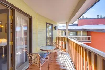 a balcony with a table and chairs at Pool and Hot Tub Access Condo in Winter Park! in Winter Park