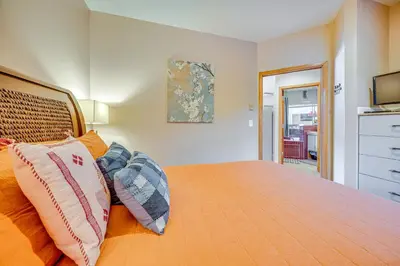 a bedroom with a bed with two pillows on it at Steps to River Run Gondola Ski Condo with Views! in Keystone