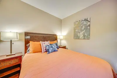 a bedroom with a large orange bed with pillows at Steps to River Run Gondola Ski Condo with Views! in Keystone