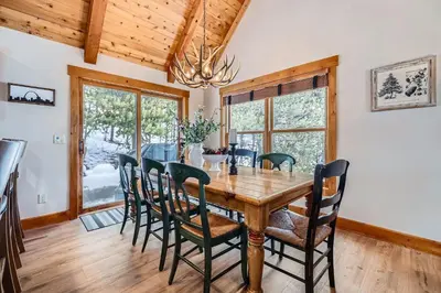 a dining room with a wooden table and chairs at 6 Cabin in the Pines home in Keystone