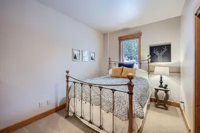 a bedroom with a bed and a window at 6 Cabin in the Pines home in Keystone