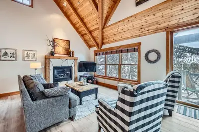a living room with two couches and a fireplace at 6 Cabin in the Pines home in Keystone