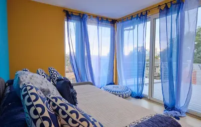a bedroom with blue curtains and a bed and a window at Denver Lower Highlands Modern Home in Denver