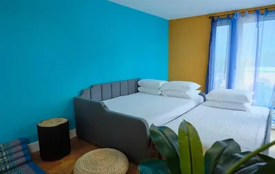 a room with a bed and a blue wall at Denver Lower Highlands Modern Home in Denver