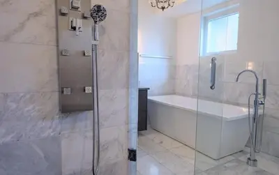 a bathroom with a shower and a tub and a sink at Denver Lower Highlands Modern Home in Denver