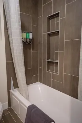 a bathroom with a bath tub and a toilet at Denver Lower Highlands Modern Home in Denver