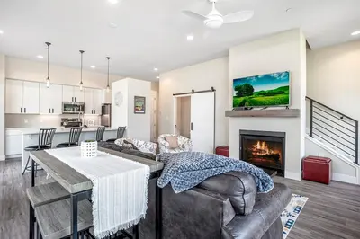 a living room with a couch and a fireplace at Cozy Downtown Condo with Jacuzzi 5 Min to Resort in Winter Park