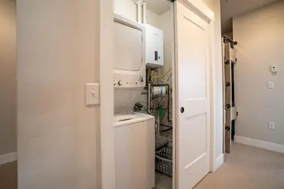 a laundry room with a washer and dryer at Cozy Downtown Condo with Jacuzzi 5 Min to Resort in Winter Park