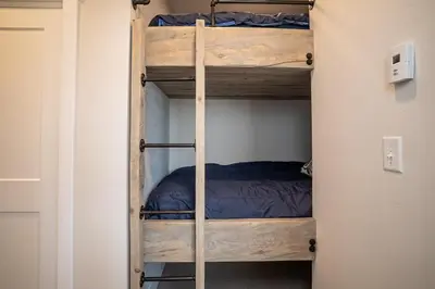 a couple of bunk beds in a room at Cozy Downtown Condo with Jacuzzi 5 Min to Resort in Winter Park