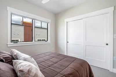 a bedroom with a bed and a large window at Cozy Downtown Condo with Jacuzzi 5 Min to Resort in Winter Park