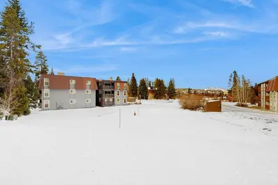 a snow covered parking lot in front of a building at Hi Country Haus 11-12 in Winter Park