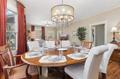 a dining room and living room with a table and chairs at City Park Charm - Vintage Home with Modern Comforts in Fort Collins
