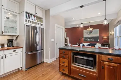 a large kitchen with a stainless steel refrigerator at City Park Charm - Vintage Home with Modern Comforts in Fort Collins