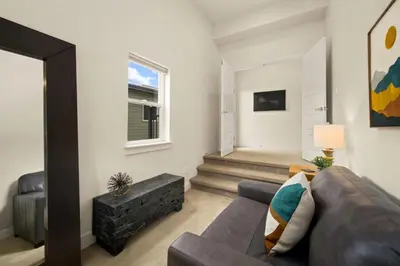 a living room with a couch and a window at The Colorado House in Old Town Brewery District in Fort Collins