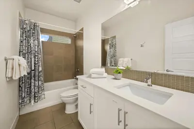 a white bathroom with a sink and a toilet at The Colorado House in Old Town Brewery District in Fort Collins