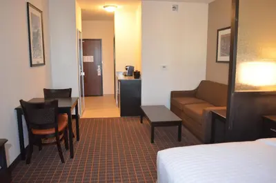 a hotel room with a bed and a couch and a table at Holiday Inn Express & Suites Golden by IHG in Golden