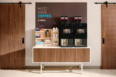 a coffee shop with a counter with a coffee maker on it at Holiday Inn Express & Suites Golden by IHG in Golden