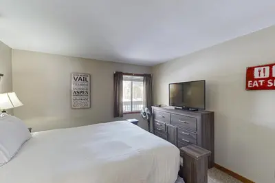 a bedroom with a bed and a flat screen tv at Lakeview Peaks in Dillon