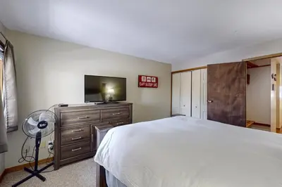 a bedroom with a bed and a flat screen tv at Lakeview Peaks in Dillon