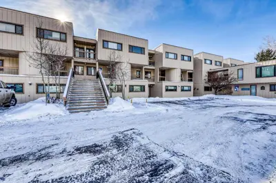 a parking lot in front of a building with snow at Lakeview Peaks in Dillon